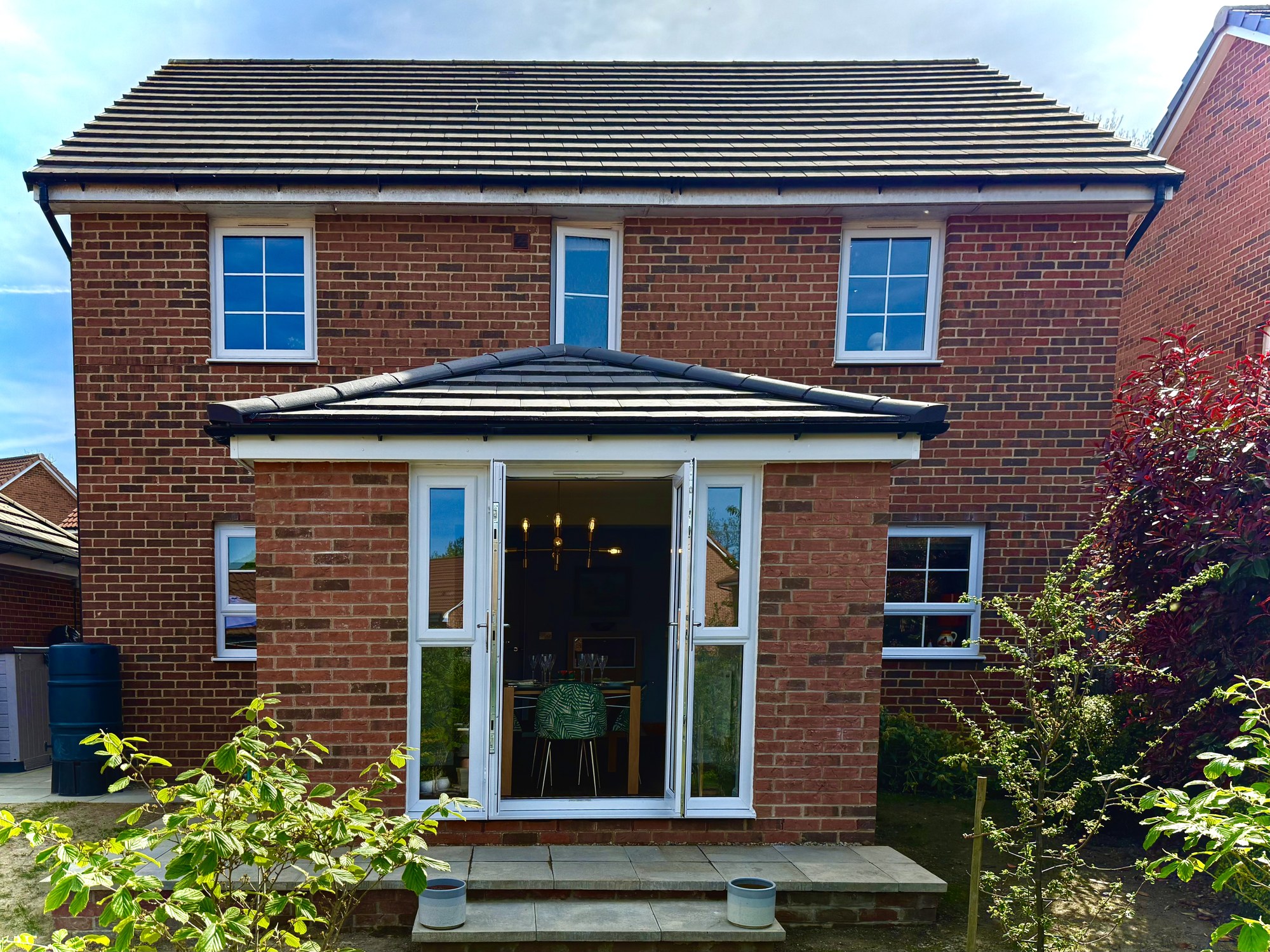 Completed brick rear house extension in Harrogate with open French doors to the garden