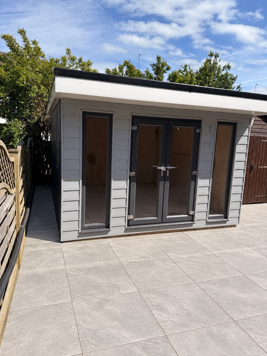 Wetherby garden room home office with light-grey composite cladding and anthracite French doors