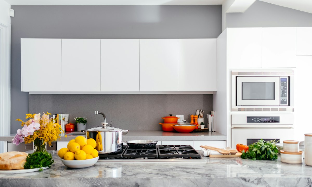 Illustrative modern kitchen with island and dining area — renovation context